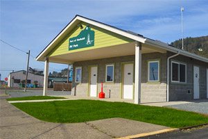 Small cement building with yellow paneling
