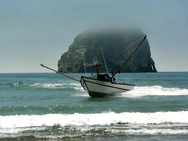 Dory boat on the water in front of Haystack Rock