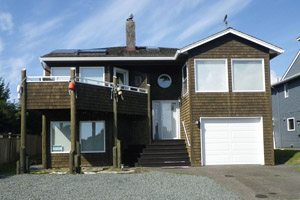 Two-story wooden-shingled house near the beach