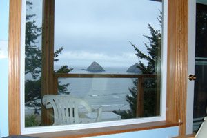 View through a window of the beach and rocks