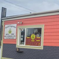 Pink and gray building with Espresso sign and big window