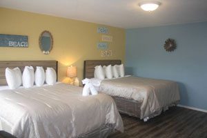 Bedroom with two beds, one blue wall, one yellow wall