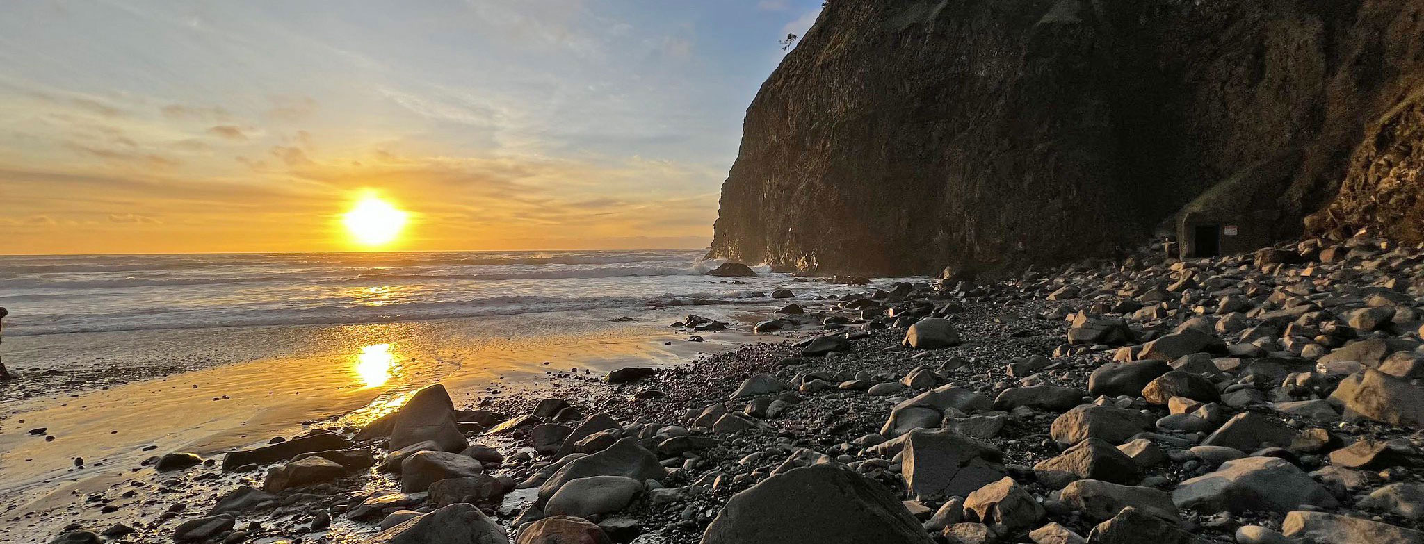 sunset rocky beach cliff