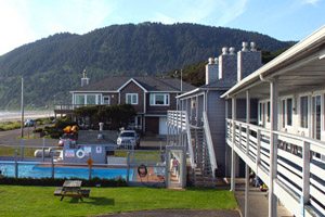Motel buildings in front of a big hill off the beach