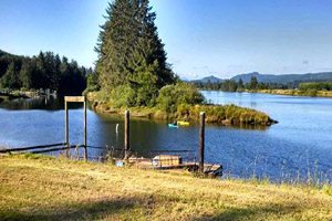 Small dock with boat, forest in the distance