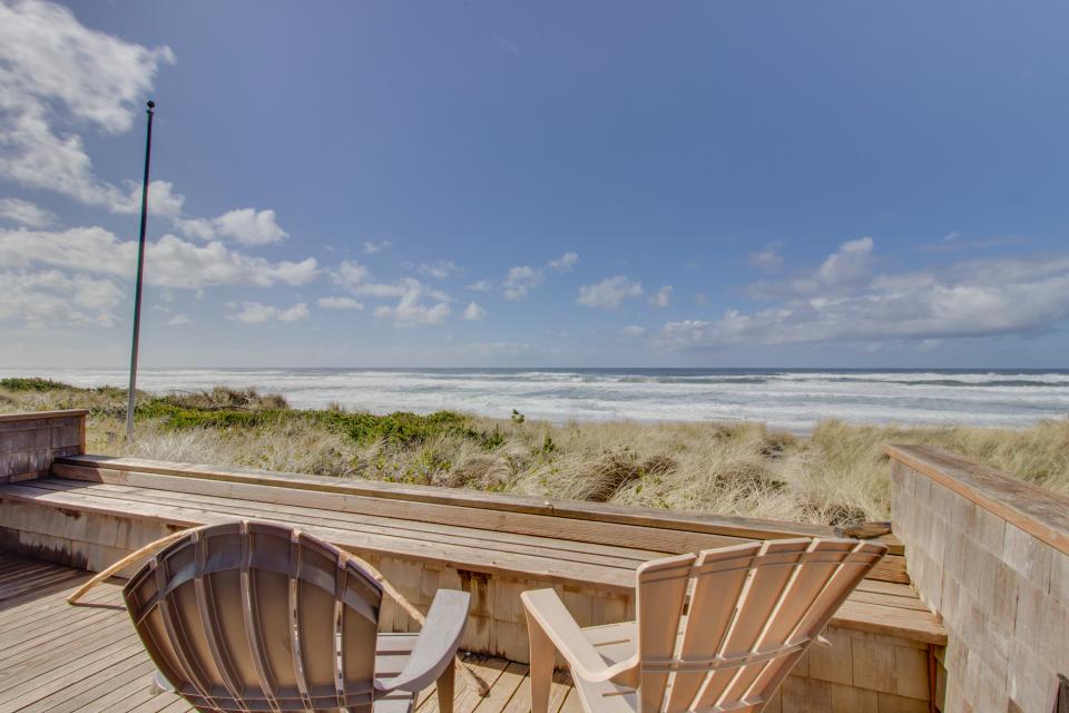 Deck with wooden chairs overlooking the beach