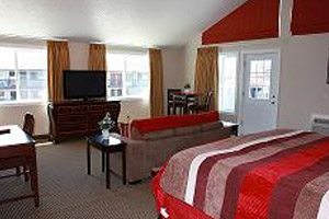 Hotel room with bed, living room and television